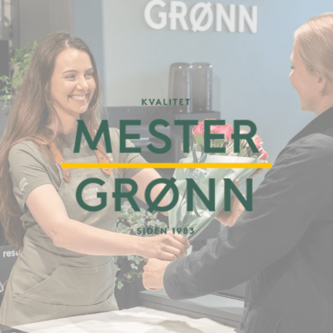 A smiling florist at Mester Grønn hands a bouquet to a customer. The store's logo and the words "KVALITET SIDEN 1983" are overlaid.