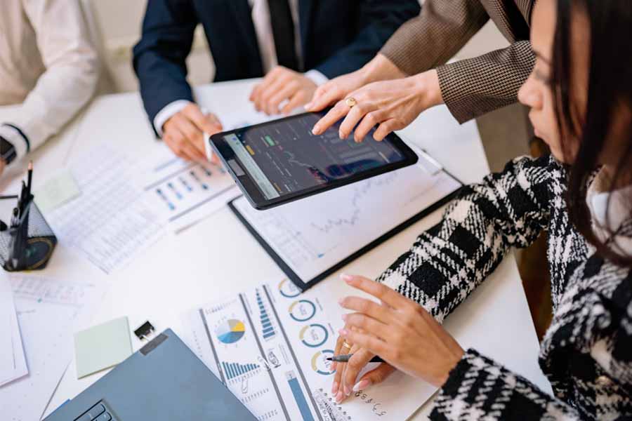 People looking at tablet dashboard