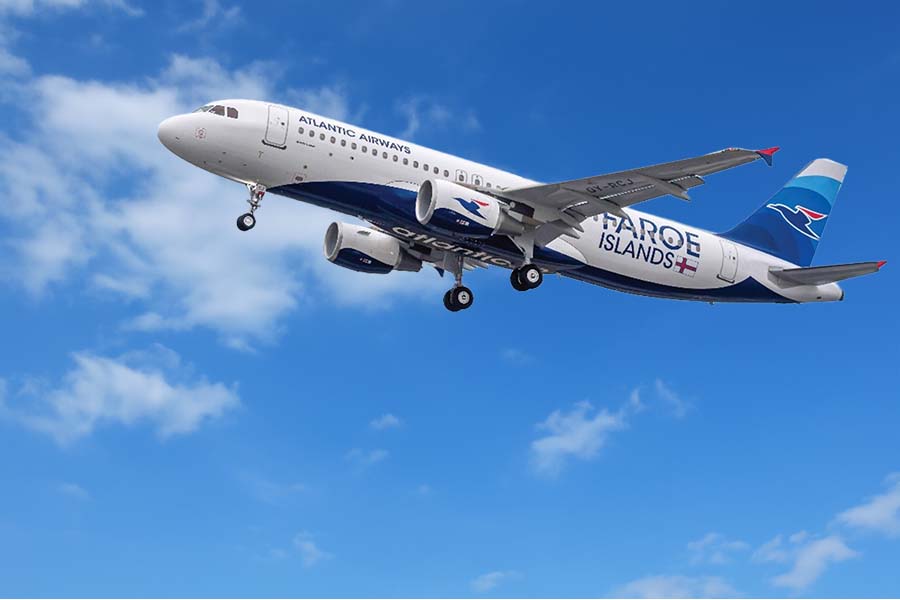 Atlantic Airways aircraft in a light blue sky with some clouds