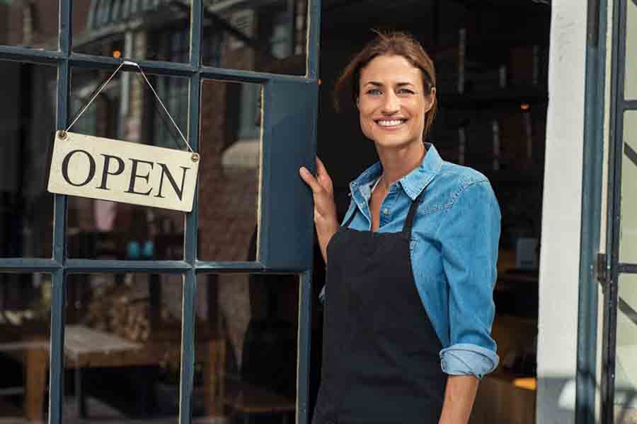 Woman at small business entrance - Alpha Solutions