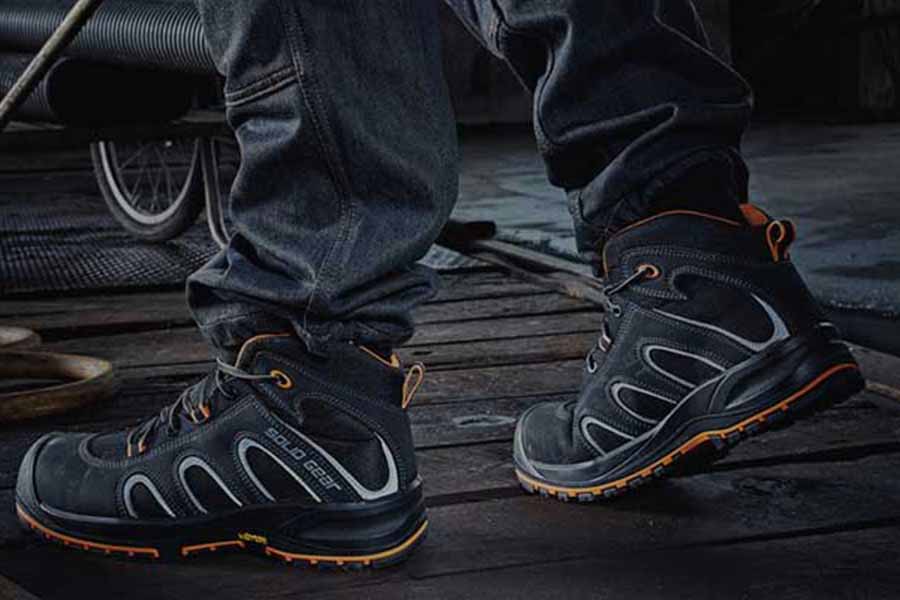 Person wearing work shoes - Alpha Solutions